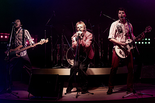 PISTOL -- A first look image from Danny Boyle and FX’s Pistol.  Left to right: Christian Lees as original bassist Glen Matlock, Anson Boon as singer John Lydon and Toby Wallace as guitarist Steve Jones.  CR: Miya Mizuno/FX